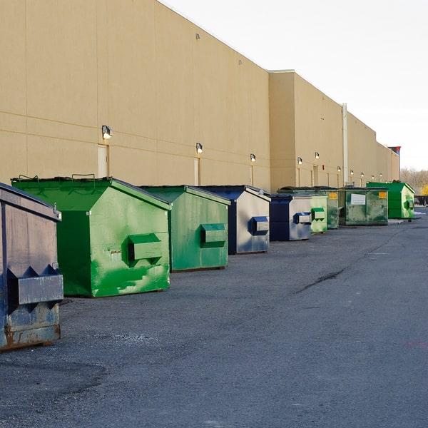 metal commercial dumpster with waste disposal signage